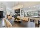 Dining area with modern light fixture, bar area, and view of the living room and kitchen at 39 Pelican Pl, Belleair, FL 33756