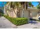 Charming brick home featuring a well-maintained lawn, a two-car garage, and mature landscaping at 39 Pelican Pl, Belleair, FL 33756