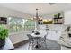 Charming breakfast nook with a kitchen view features updated white cabinets, granite counters and stainless appliances at 39 Pelican Pl, Belleair, FL 33756