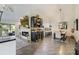 Bright open-concept living room with fireplace, dining area, bar, and kitchen perfect for entertaining at 39 Pelican Pl, Belleair, FL 33756