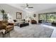 Bright living room features vaulted ceiling, comfortable seating, stylish decor, and access to outdoor balcony at 39 Pelican Pl, Belleair, FL 33756