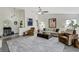 Spacious living room with vaulted ceiling, neutral walls, hardwood floors, and designer furniture at 39 Pelican Pl, Belleair, FL 33756