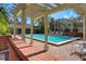 Inviting community pool with lounge chairs and a pergola, perfect for relaxing on a sunny day at 39 Pelican Pl, Belleair, FL 33756