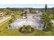 Aerial view of community center pool, surrounded by lounge chairs, umbrellas, and lush green landscaping at 4069 102Nd N Pl, Clearwater, FL 33762