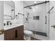 Updated bathroom features vanity and sleek shower with subway tile and glass door at 4069 102Nd N Pl, Clearwater, FL 33762