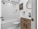 Bright bathroom featuring a tub with subway tile surround and modern vanity with wood cabinetry and matte black fixtures at 4069 102Nd N Pl, Clearwater, FL 33762