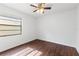 Bedroom with neutral wall color, ceiling fan and window view offering a serene living space at 4069 102Nd N Pl, Clearwater, FL 33762
