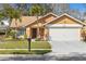 Charming single-story home showcasing a manicured lawn, palm trees, and a two-car garage at 4069 102Nd N Pl, Clearwater, FL 33762