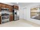 Kitchen with stainless steel appliances, wood cabinets and white tile flooring at 4069 102Nd N Pl, Clearwater, FL 33762