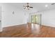 Bright living room featuring vaulted ceiling, ceiling fan and sliding glass doors to outdoor space at 4069 102Nd N Pl, Clearwater, FL 33762