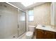 Bathroom featuring a glass enclosed shower, a window for natural light, and a vanity sink at 4582 Fox Lake Ct, Clearwater, FL 33762
