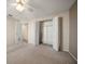 Neutral bedroom featuring carpet, a ceiling fan, and a closet at 4582 Fox Lake Ct, Clearwater, FL 33762