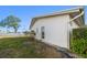 A view of the white exterior of a single-story house with a green lawn and blue sky in the background at 4582 Fox Lake Ct, Clearwater, FL 33762