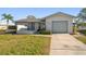 Inviting single-story home with attached garage and landscaped front yard with green lawn at 4582 Fox Lake Ct, Clearwater, FL 33762