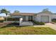 Charming single-story home with a well-manicured lawn, a palm tree, and an attached garage at 4582 Fox Lake Ct, Clearwater, FL 33762