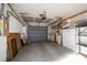 Spacious garage features ample lighting, storage shelves, and equipment; overhead door at 4582 Fox Lake Ct, Clearwater, FL 33762