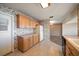 Kitchen features wood cabinets, tile floors and a door leading to the exterior at 4582 Fox Lake Ct, Clearwater, FL 33762