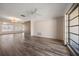 Bright, expansive living room with hardwood floors, a ceiling fan, and natural light at 4582 Fox Lake Ct, Clearwater, FL 33762