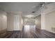 Open-concept living room with neutral paint, fan, and wood floors flowing into adjoining rooms at 4582 Fox Lake Ct, Clearwater, FL 33762