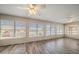 Bright sunroom with hardwood floors, plenty of windows, and ceiling fans for comfort at 4582 Fox Lake Ct, Clearwater, FL 33762