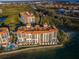 Stunning aerial view of waterfront condos with a pool and lush landscaping on a sunny day at 4830 Osprey S Dr # 305, St Petersburg, FL 33711