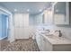 Bright bathroom features double sinks, pebble flooring, a glass enclosed shower, and ample storage at 4830 Osprey S Dr # 305, St Petersburg, FL 33711