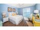 Relaxing bedroom with blue walls, wood floors, and a large window with water views at 4830 Osprey S Dr # 305, St Petersburg, FL 33711