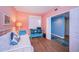 Cozy bedroom with wood floors, bright walls, and a glimpse into an adjoining blue-walled area at 4830 Osprey S Dr # 305, St Petersburg, FL 33711
