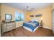 Bright bedroom with yellow walls, wood floors, and a large window at 4830 Osprey S Dr # 305, St Petersburg, FL 33711