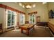 Well-lit billiard room featuring a pool table, large windows, and a seating area at 4830 Osprey S Dr # 305, St Petersburg, FL 33711