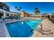 Community pool with crystal clear blue water and ample lounge seating around the perimeter at 4830 Osprey S Dr # 305, St Petersburg, FL 33711