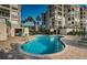 Inviting community pool surrounded by lounge chairs and lush landscaping on a bright day at 4830 Osprey S Dr # 305, St Petersburg, FL 33711
