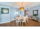 Dining room with wood floors, pendant lighting, and sailboat accents at 4830 Osprey S Dr # 305, St Petersburg, FL 33711