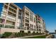 Exterior shot of an elegant condo with multiple balconies and waterfront views on a sunny day at 4830 Osprey S Dr # 305, St Petersburg, FL 33711