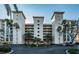 Picture of the condo's exterior with well-maintained landscaping, ample parking, and a circular drive at 4830 Osprey S Dr # 305, St Petersburg, FL 33711