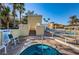 Inviting in-ground hot tub with clear water next to a staircase and community pool at 4830 Osprey S Dr # 305, St Petersburg, FL 33711