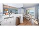 Open kitchen with sleek appliances and view of dining area and waterfront at 4830 Osprey S Dr # 305, St Petersburg, FL 33711
