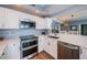 Well-equipped kitchen with modern appliances and adjacent dining area at 4830 Osprey S Dr # 305, St Petersburg, FL 33711