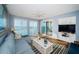 Bright living room featuring waterfront views, cozy seating, and access to a private balcony at 4830 Osprey S Dr # 305, St Petersburg, FL 33711