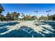 Aerial view of a community tennis court featuring mature trees and manicured landscape at 4830 Osprey S Dr # 305, St Petersburg, FL 33711