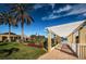 Scenic walkway with pergola overlooking lake and landscaped grounds on a clear, sunny day at 4830 Osprey S Dr # 305, St Petersburg, FL 33711