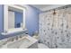 Charming bathroom with a seashell-themed shower curtain and white marble counter at 5024 Cedarbrook Ln, Hernando Beach, FL 34607