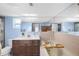 Well-lit bathroom featuring a bathtub and a vanity with marble countertop at 5024 Cedarbrook Ln, Hernando Beach, FL 34607