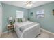 Comfortable bedroom features a large window and calm, inviting pastel blue wall color at 5024 Cedarbrook Ln, Hernando Beach, FL 34607