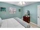Relaxing bedroom showcases a plush bed, dresser, and a soothing light blue paint at 5024 Cedarbrook Ln, Hernando Beach, FL 34607