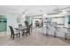Open concept dining area next to kitchen with tile floors, coastal decor, and lots of natural light at 5024 Cedarbrook Ln, Hernando Beach, FL 34607