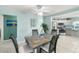 Dining area with a decorative table, overlooking the kitchen with stainless appliances and coastal decor at 5024 Cedarbrook Ln, Hernando Beach, FL 34607