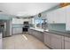Bright kitchen featuring stainless steel appliances, white cabinetry, and a large window overlooking the water at 5024 Cedarbrook Ln, Hernando Beach, FL 34607