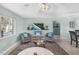 Cozy living room featuring comfortable seating, a ceiling fan, a flat-screen TV, and a coastal color scheme at 5024 Cedarbrook Ln, Hernando Beach, FL 34607