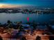 Night aerial view of waterfront home with illuminated pool and scenic bay views at 505 55Th Ave, St Pete Beach, FL 33706